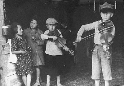 Jewish children in the Krakow ghetto play violins for the cameraman 1939 - 1940.
